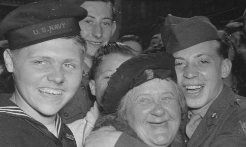 Jubilant American soldiers, seamen and civilians celebrating Germany's unconditional surrender at London, England, May 7, 1945
