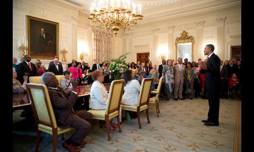 President Obama speaking to group of people in White House.